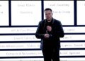 Elon Musk stands in front of xAI's new org chart
