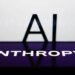 AI sign displayed on a screen and Anthropic logo displayed on a phone screen are seen in this illustration photo.