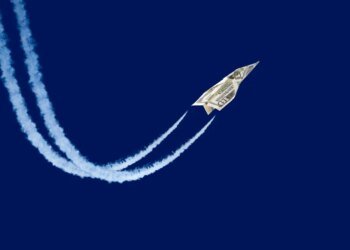 Dollar shaped paper airplane flying up