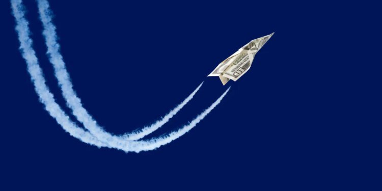 Dollar shaped paper airplane flying up