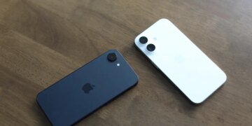 Two Apple iPhone 16e units splayed on table