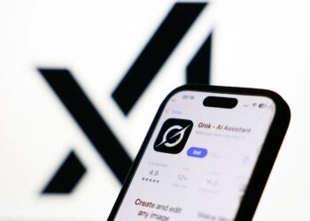 xAI logo displayed on a screen and Grok on App Store displayed on a phone screen