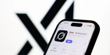 xAI logo displayed on a screen and Grok on App Store displayed on a phone screen