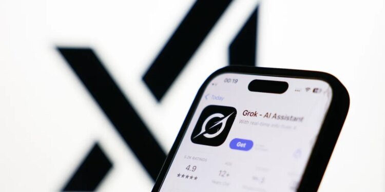 xAI logo displayed on a screen and Grok on App Store displayed on a phone screen
