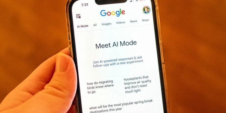 A person holding an iPhone and using Google AI Mode