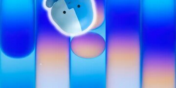 Apple Finder Happy Mac guy against MacBook Neo wallpaper