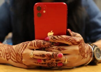 red iPhone held in two hands