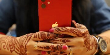 red iPhone held in two hands