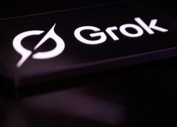 The Grok logo is displayed on a mobile phone screen