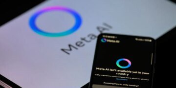 The Meta AI app is displayed on a mobile phone with the Meta AI logo visible on a tablet in this photo illustration