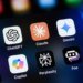 Popular AI virtual assistant apps on an Apple iPhone: ChatGPT, Claude, Gemini, Copilot, Perplexity, and Poe.
