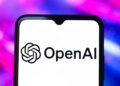 The OpenAI logo is seen displayed on a smartphone screen.