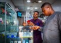 A customer browses mobile phone handsets inside a shop at the Ikeja computer village market in Lagos, Nigeria, on Monday, March 29, 2021.