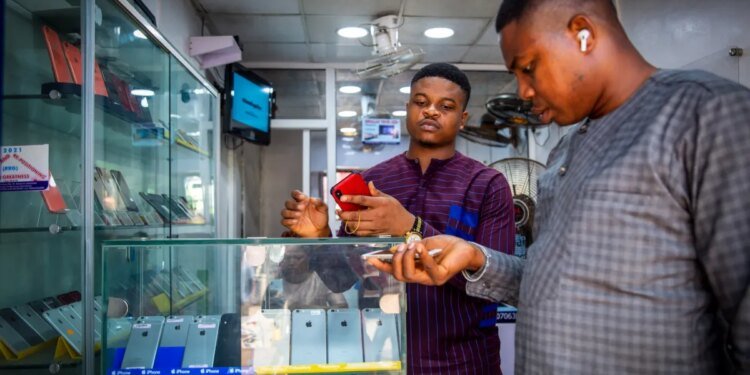 A customer browses mobile phone handsets inside a shop at the Ikeja computer village market in Lagos, Nigeria, on Monday, March 29, 2021.
