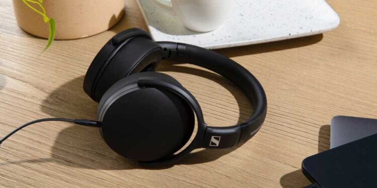 Photo of HD 400U headphones on table beside iPhone